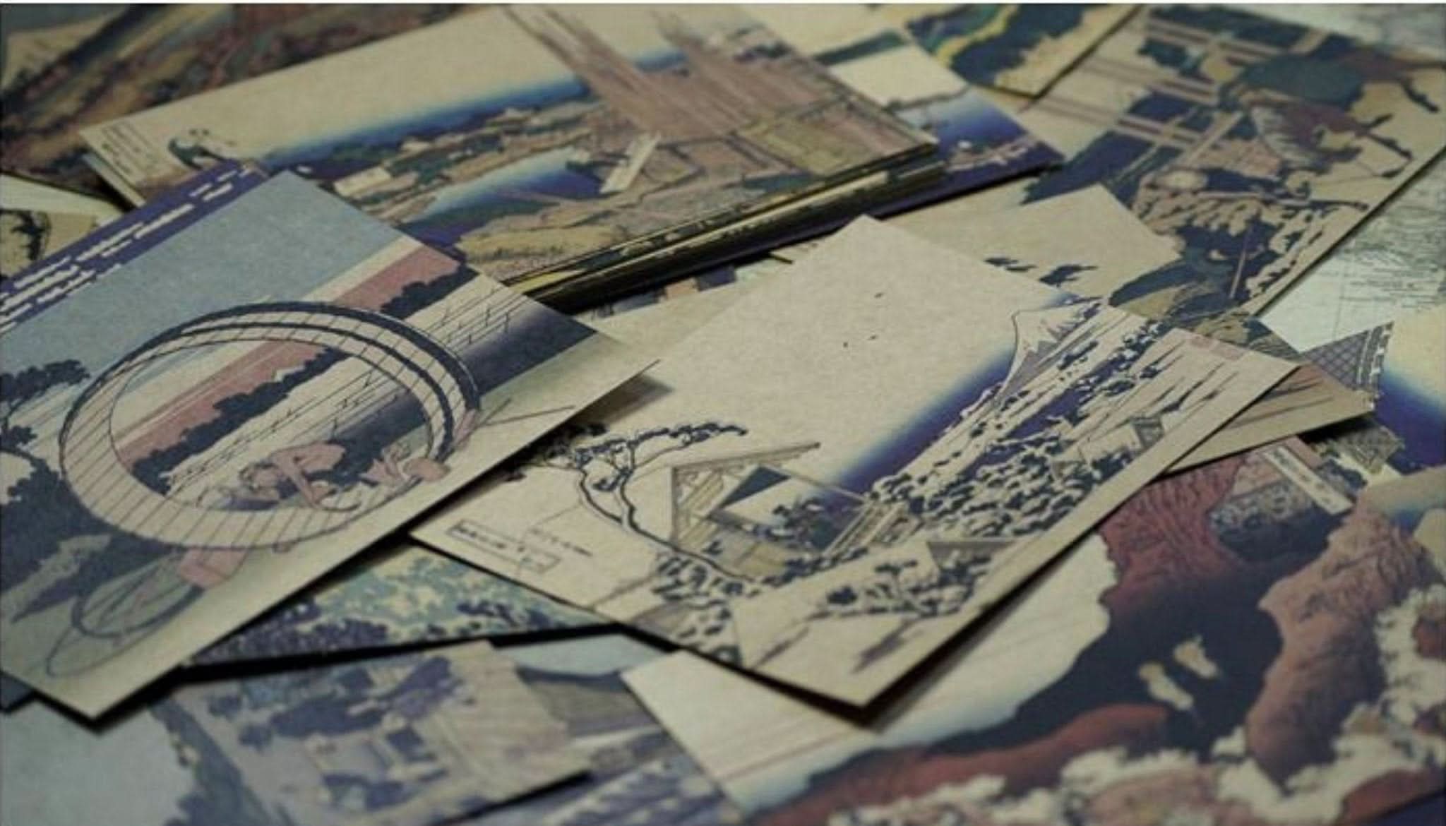 Hokusai Japanese Art Postcards: Ukiyo-e scenes in blue, brown, and earth tones on paper.